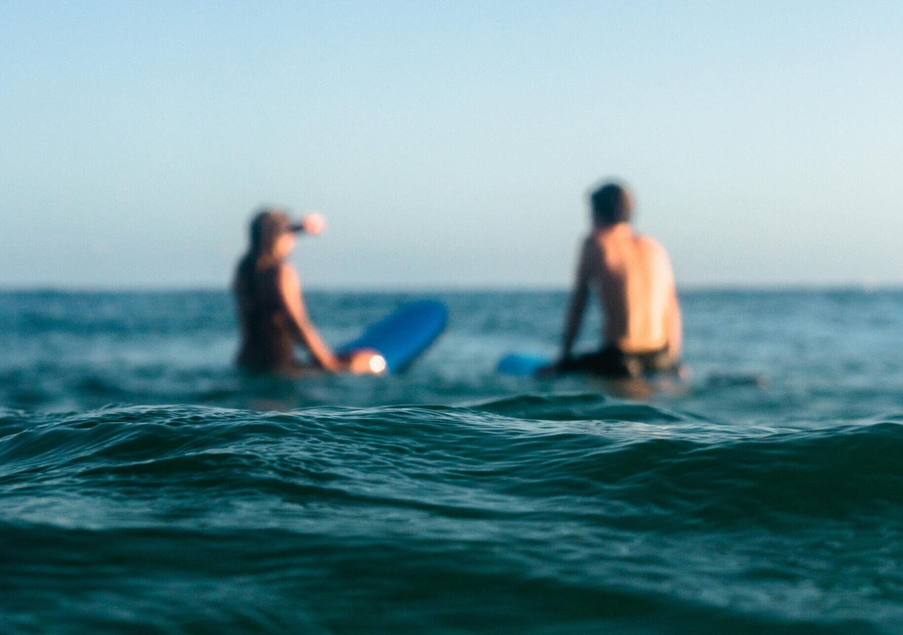 Two Person Riding Blue Bodyboard